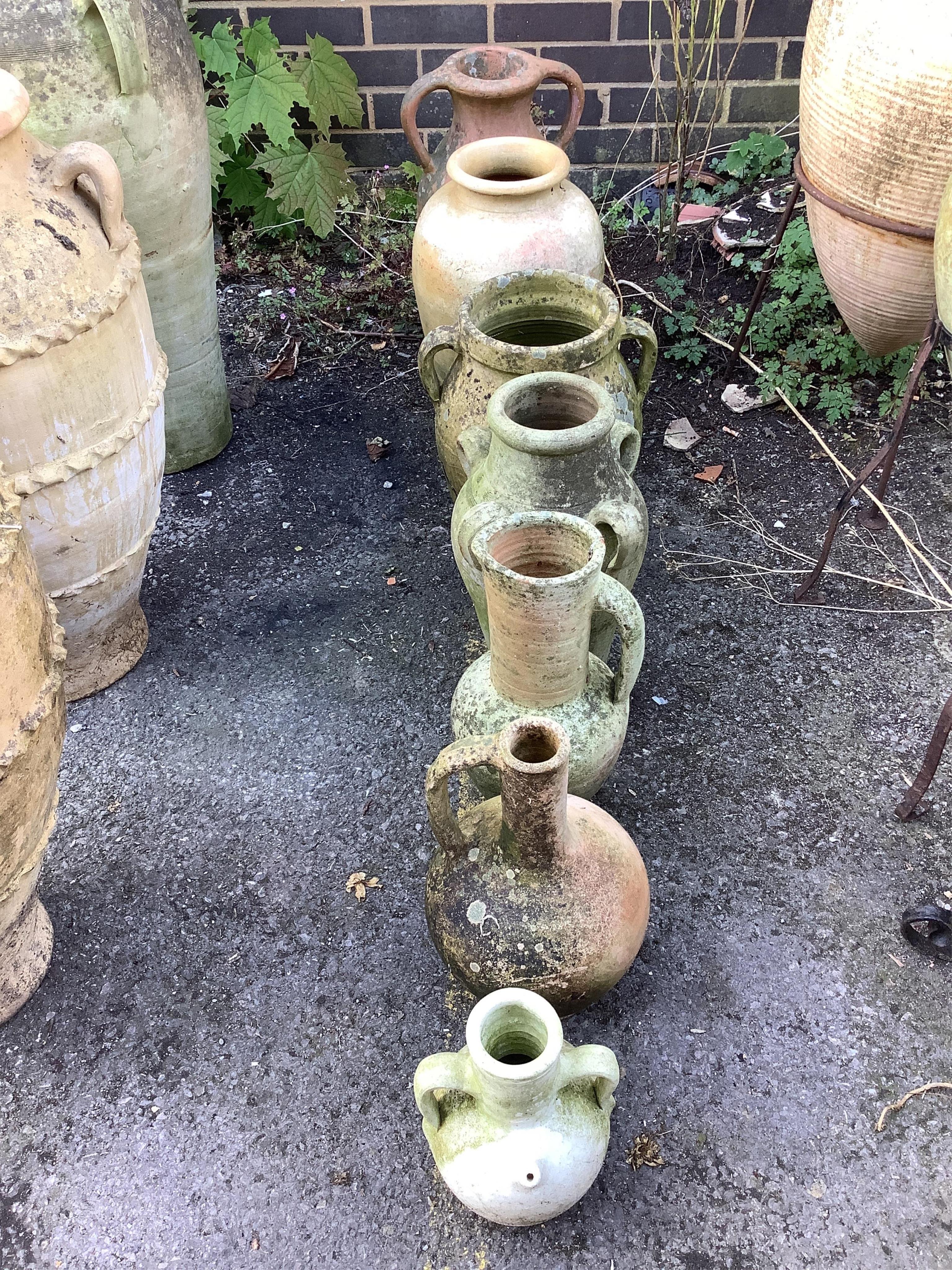 Seven terracotta and earthenware jars and urns, largest height 48cm. Condition - fair